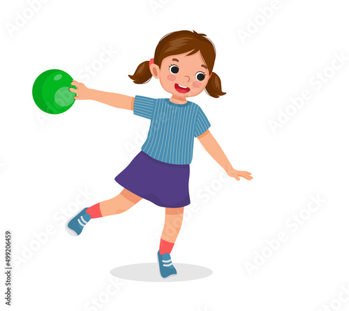 happy little girl playing bowling in the sport club ready to throw the ball