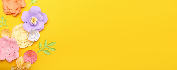 Beautiful handmade paper flowers on yellow background with space for text