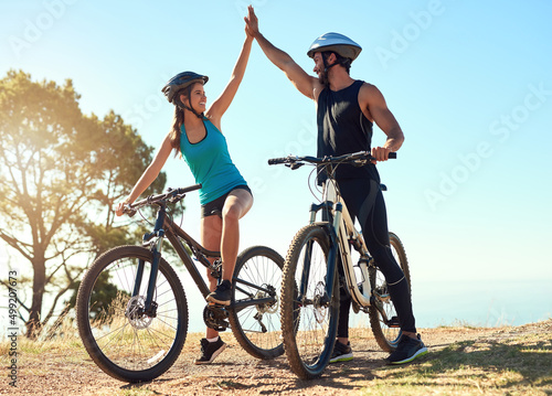 Fototapeta Naklejka Na Ścianę i Meble -  That ride was awesome. Shot of a happy young couple out mountain biking together.