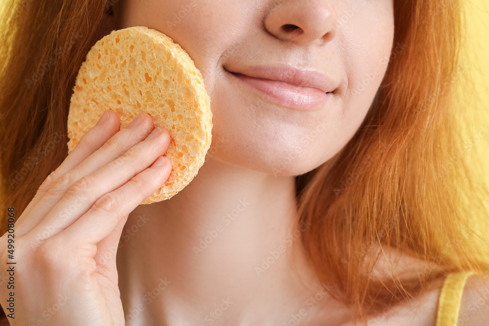 Young woman with makeup sponge on color background, closeup Young woman with makeup sponge on color background, closeup