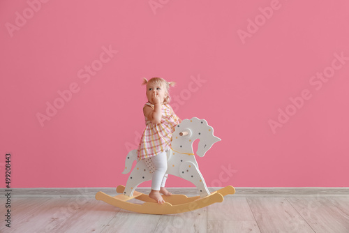 Adorable baby girl with roc...