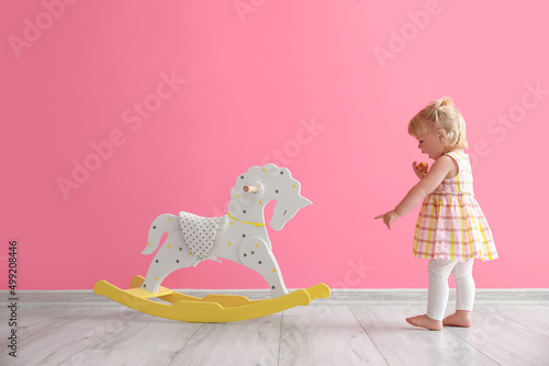 Adorable baby girl with roc...
