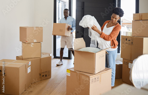 Moving can be such a mission. Shot of a young couple packing their belongings at home. © Courtney H/peopleimages.com