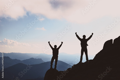 victory of successful mountaineers at the top of the mountain range