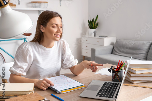 Student video chatting with tutor online at home