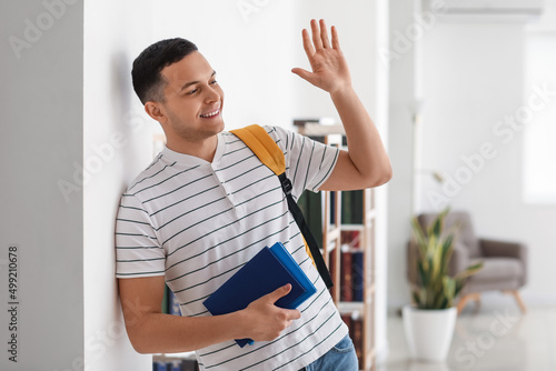 Male student with books wav...