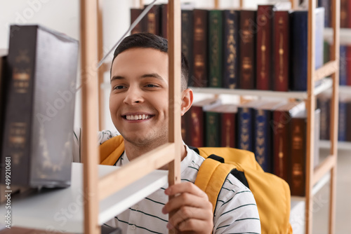 Male student near bookshelf...