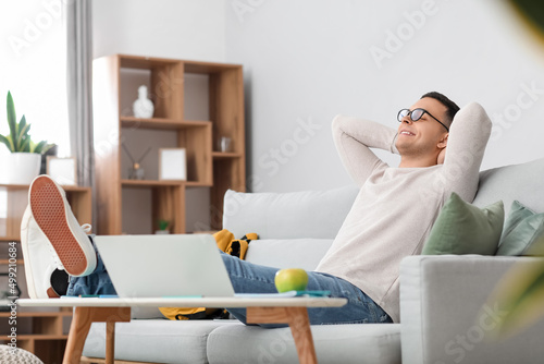 Male student relaxing on so...