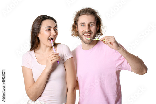 Happy young couple brushing...