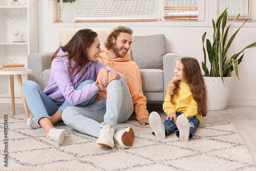 Young family sitting on sof...