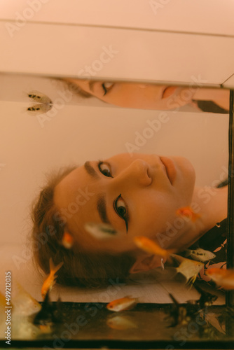 porrait of woman underwater with fish concept photo