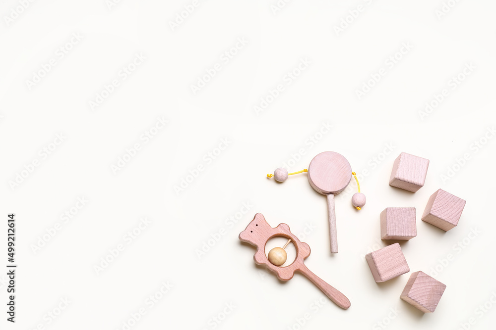 Wooden cubes with baby rattles on white background Wooden cubes with baby rattles on white background
