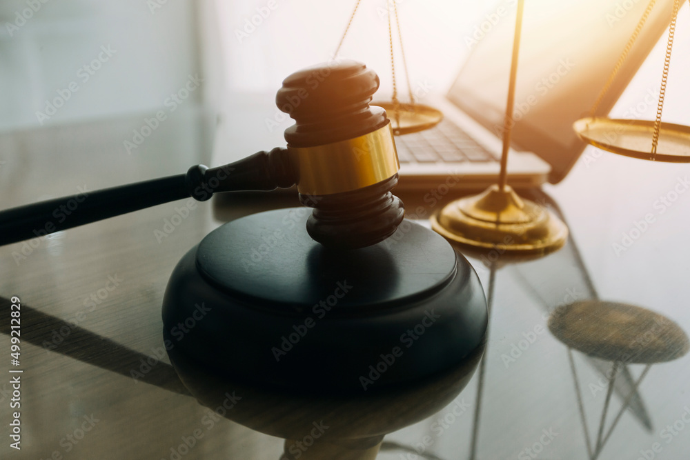 law books and scales of justice on desk in library of law firm. jurisprudence legal education concept. law books and scales of justice on desk in library of law firm. jurisprudence legal education concept.