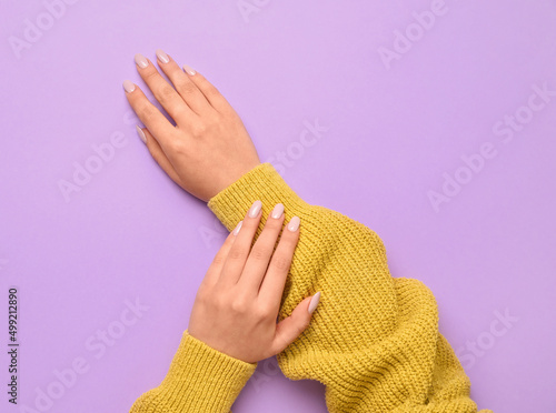 Woman with stylish manicure on color background, closeup
