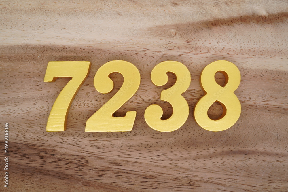 Poster Golden Arabic numerals on a real brown and white wooden floor ...