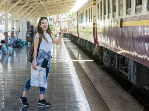Asia woman Traveller feeling happiness and greeting her friend before go to travel at the train station  Travel and lifestyle concept