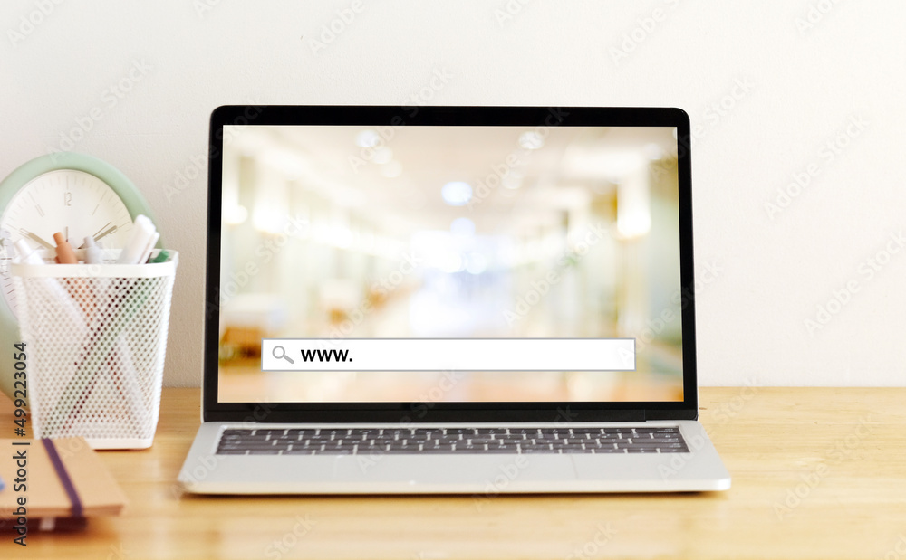 Labtop computer with www. on search bar over blur store background on ...