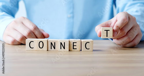 Hand holding  wooden cubes with connect word, business concept