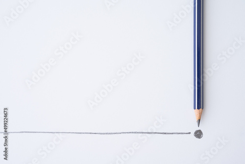 Flat lay of blue pencil write line and end point on white paper background copy space. Business conclusion, creative idea, imagination and education concept. photo