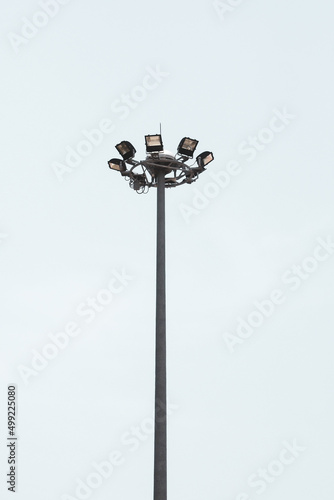 Electric poles and large spotlights provide light. on a white background