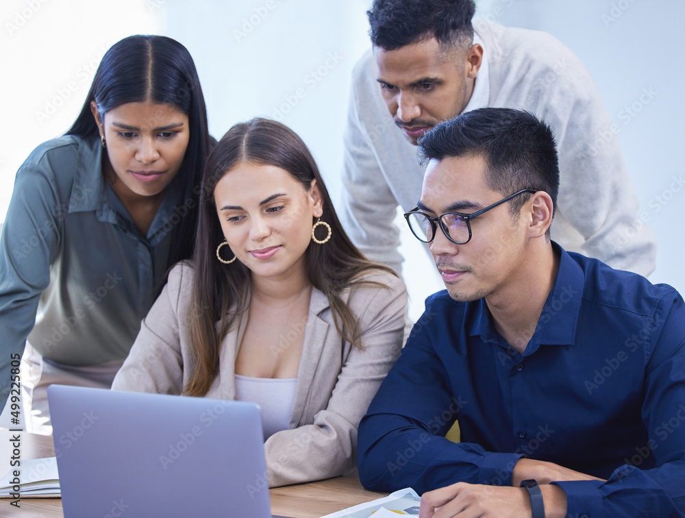 Collaborating to finish their tasks with speed. Shot of a group of businesspeople working together on a laptop in an office. Collaborating to finish their tasks with speed. Shot of a group of businesspeople working together on a laptop in an office.