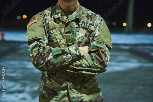 True soldiers stand their ground. Cropped shot of a soldier standing outside on a cold night at a military academy.