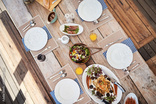 Special meals that bring people together. High angle shot of a table setting with food and drinks outdoors. photo
