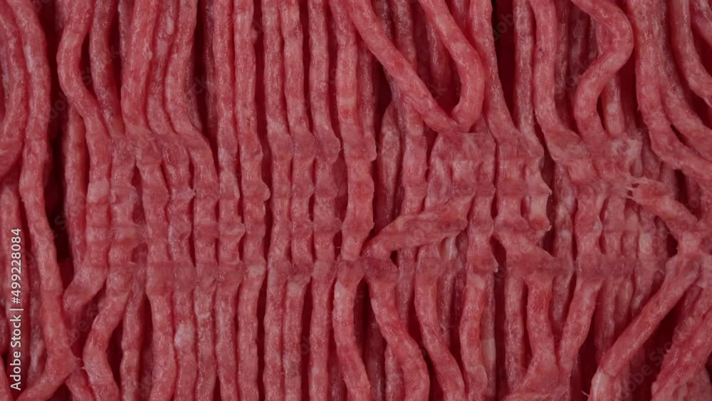 Minced meat top view. Black fork over minced meat 