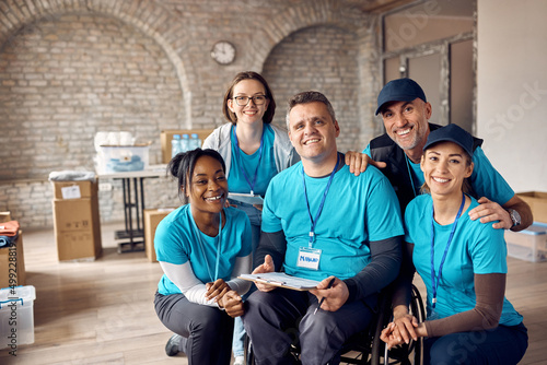 Portrait of happy diverse volunteers working at community center and looking at camera. photo