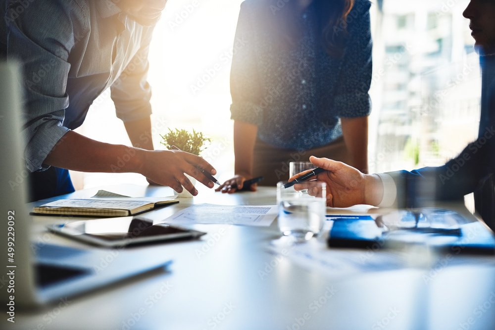 Brainstorming ways to improve business. Closeup shot of unidentifiable businesspeople working together in an office. Brainstorming ways to improve business. Closeup shot of unidentifiable businesspeople working together in an office.