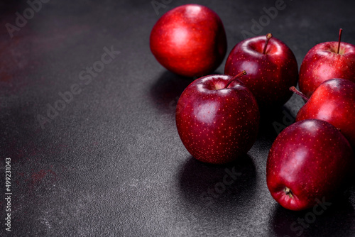 Delicious fresh apples in red on a dark concrete background