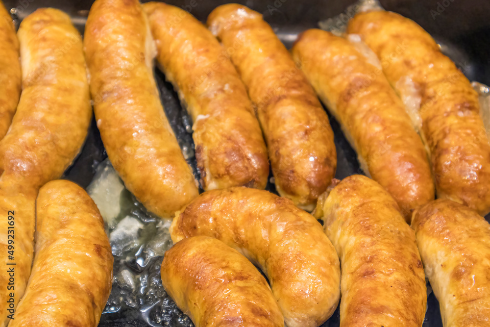 fried homemade rustic sausages close-up as background fried homemade rustic sausages close-up as background