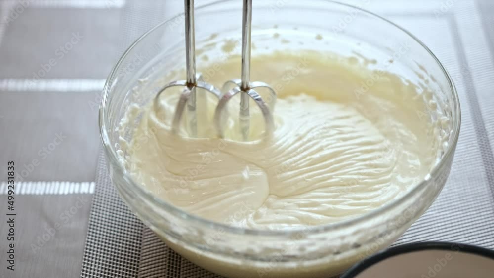 Whipping cream cheese in a glass bowl Whipping cream cheese in a glass bowl