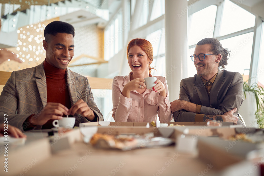 A young cheerful business woman and her male colleagues are in a very good mood during a lunch break in the company building. Business, people, company - obrazy, fototapety, plakaty 