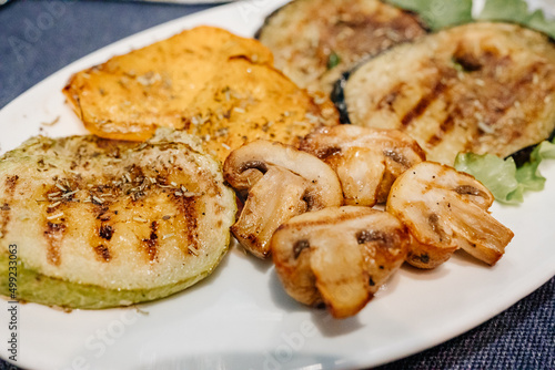 grilled mushrooms, eggplant, zucchini and bell peppers on a plate. 