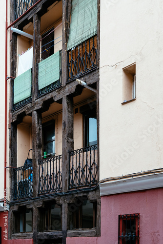 Low angle view of old cast iron balconies of old residential building in Lavapies quarter in Madrid