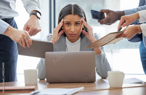 This is too much for me. Shot of a young businesswoman feeling stressed out in a demanding office environment at work.