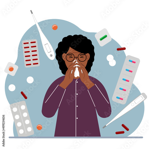 A woman covers his nose with his hands with a handkerchief. The concept of a cold person, seasonal allergies. Lots of medicines and thermometers.