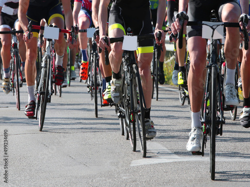 cyclists pedaling fast on bicycles during road cycling race