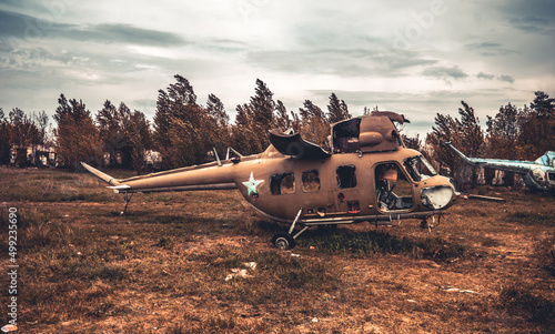 Abandoned old USSR helicopter military technique at the airfield