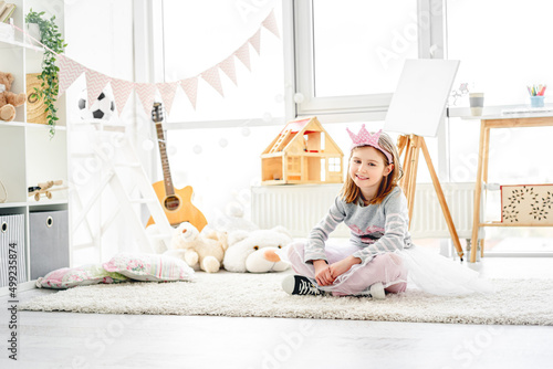 Cute little princess sitting in children's room