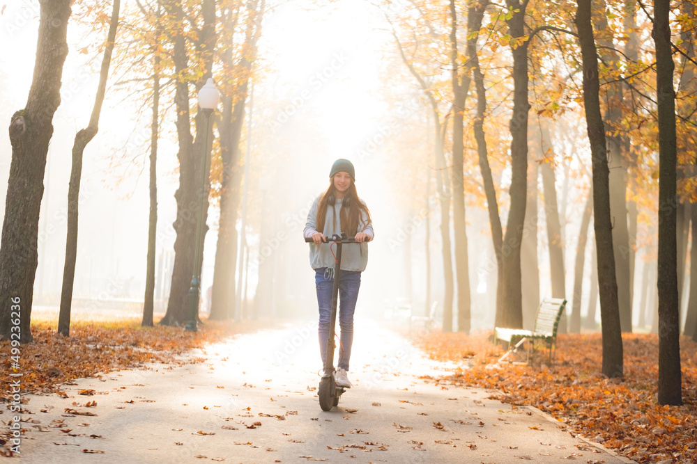 girl on scooter in autumn park girl on scooter in autumn park