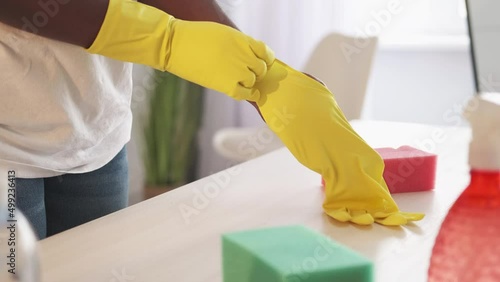 Wallpaper Mural Home cleaning service. Housekeeping business. Maid work. Female janitor hands wearing gloves at table with chemical containers sponges supplies at light interior. Torontodigital.ca