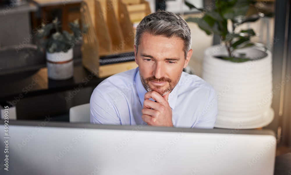Hard work is what pays the bills. Shot of a businessman looking thoughtful while sitting at his desk. Hard work is what pays the bills. Shot of a businessman looking thoughtful while sitting at his desk.