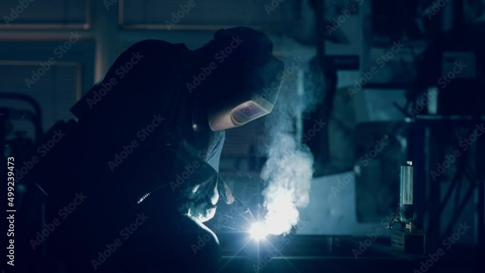 Welder wearing a protective mask welding metal Stock-Video | Adobe Stock