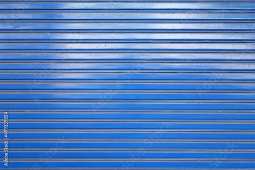 blue metal roller shutter door, corrugated steel sheet of storefront gate