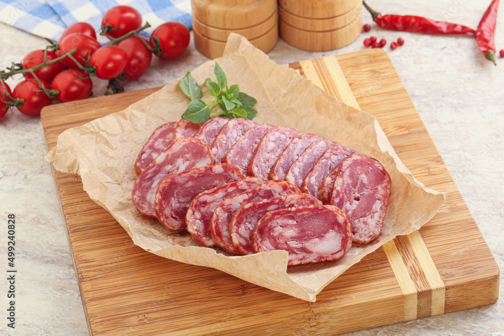 Sliced salami sausages over board Sliced salami sausages over board