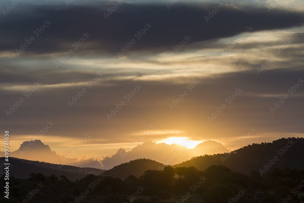 Sunrise over the mountains, silhouette of the mountains, sky, clouds. Santa Ponca, Mallorca, Spain.	

