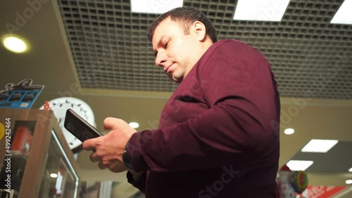 man holds mobile phone in his hand video filming from below
