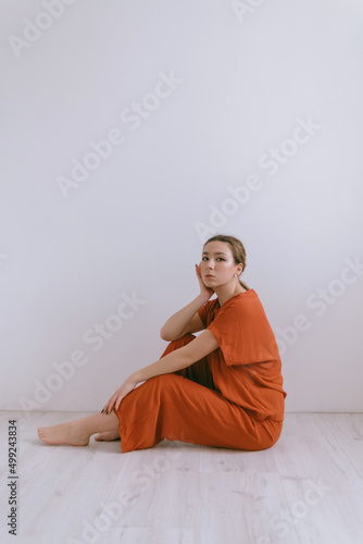 Portrait of young caucasian woman in red cloth. © Eugene